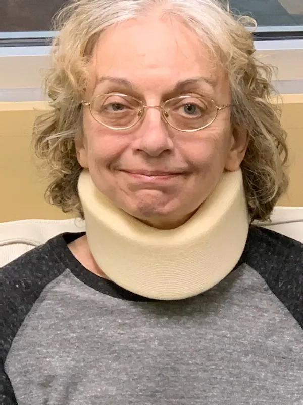 Portrait of Lenora wearing a cervical support collar during recovery from brain tumor surgery.
