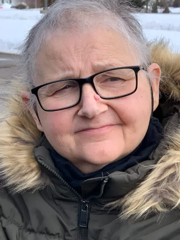 Portrait of Margaret outdoors following recovery from emergency brain surgery.